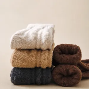 Thickened men's winter wool warm socks stacked display, soft plush thermal long boot socks
