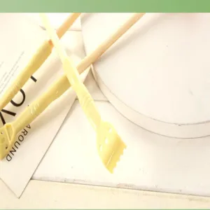 Manual back scratcher with wooden handle and plastic massage head for body relaxation.