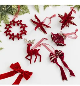 Detailed view of burgundy flocked Christmas ornaments set on white background
