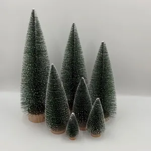 Set of seven mini snow-covered Christmas trees in various sizes for desktop decor