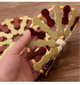 Foldable wooden trivet detail showing bamboo heat insulation mat structure and pot holder.