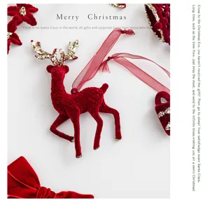 Detailed view of a burgundy flocked reindeer Christmas tree ornament with glittery antlers