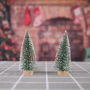 Pair of mini snow-flocked cedar Christmas trees with wooden bases for holiday decor