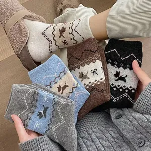 Close-up detail of cozy knit winter socks featuring cute puppy and bow patterns, warm and soft.