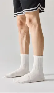 Detail shot of white ribbed crew socks worn with shorts, showcasing breathable cotton fabric.