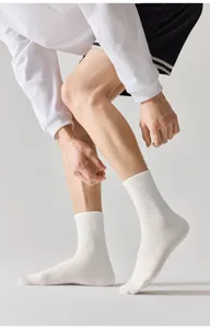 Detail shot of white mid-tube cotton socks showing ribbed cuff and breathable knit texture.