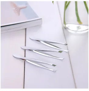 Stainless steel eyebrow tweezers detail view, precision slant tip makeup hair removal tool.