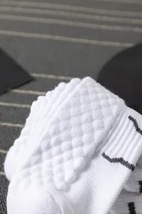 Close-up detail of thickened towel bottom white sports socks with breathable waffle texture.