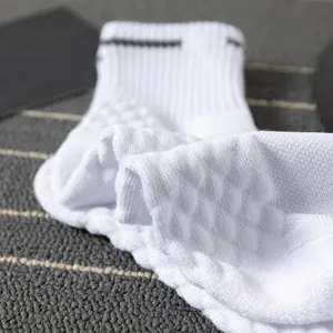Detailed close-up of white men's sports athletic cushion socks with thickened towel bottom.