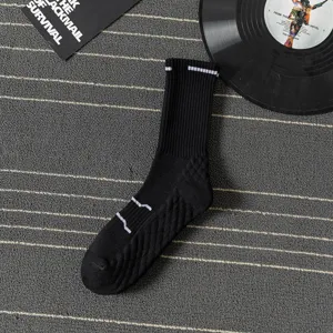 Detailed view of men's black athletic mid-calf socks with breathable knit and cushion sole.