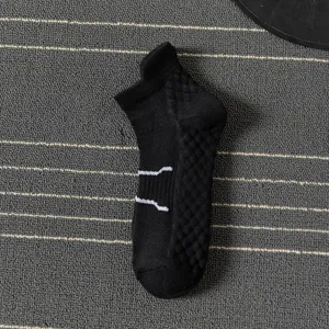 Detail view of men's black athletic sport sock with breathable knit pattern and white stripes.