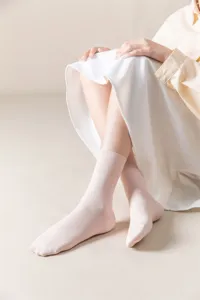 Detail closeup of women light pink ribbed mid tube socks, soft cotton blend, comfort daily wear.