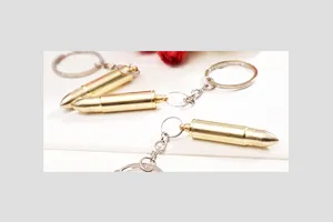 Metal bullet shaped keychain ear spoon portable mini key ring novelty creative tool accessory.