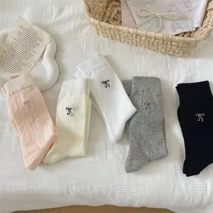 Detail view of summer thin mesh bow embroidery mid-tube socks in five versatile colors.