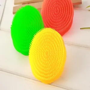 Soft silicone scalp massage brush detail view, vibrant colors, dense bristles for daily cleaning.