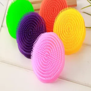 Silicone scalp massage brush detail view, soft rubber bristles for hair washing and cleaning.
