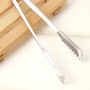 Stainless steel food tong detail close-up, serrated edge design for kitchen and buffet.