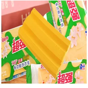 Close-up detail shot of the yellow laundry soap bar showing its cleaning texture and sturdy form.