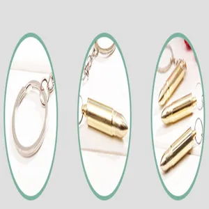 Detail view of the metal bullet shape keychain ear pick, showing key ring and metal chain structure.
