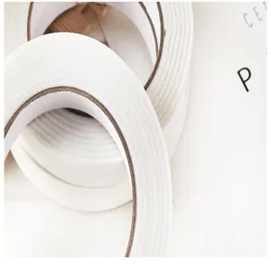 Detailed close-up of white double-sided foam tape rolls, strong adhesive for home and office.