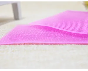 Close-up detail shot of pink hair fringe grip pad, showing fine hook texture and fabric surface.