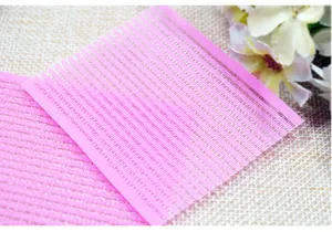 Close-up detail of pink hair magic grip pads, featuring secure teeth holding bangs in place easily.