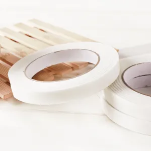 White double-sided foam tape rolls for office and home use, strong adhesive fixing tape.