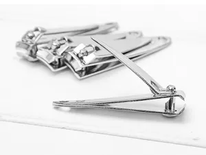 Close-up detail shot of shiny electroplated metal nail clipper, smooth finish daily tool.