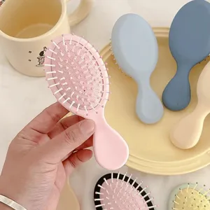 Cute macaron color portable massage cushion hair brush for daily hair styling and travel use.