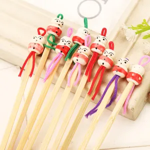 Natural handmade wooden ear pick with cute doll head and colorful lanyard for daily use.