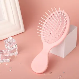Pink macaron massage hair brush detail view, portable airbag comb showing soft cushion and teeth.