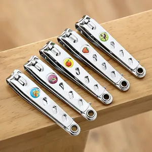 Stainless steel nail clipper set with file hole and cute fruit pattern keychain pendant.
