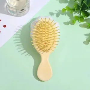 Compact macaron cushion hair brush for daily hair care, portable cute cartoon styling tool.