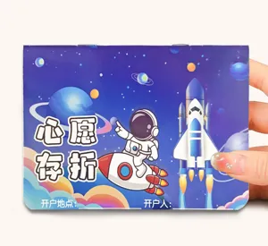 Detail of kids space theme savings passbook featuring astronaut and rocket illustration.