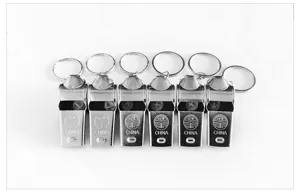 Detailed shot of metal referee whistles with keyrings, neatly arranged for sports use.
