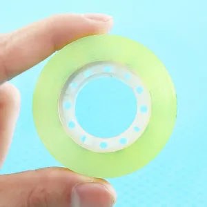 Small transparent adhesive tape for office and school stationery, high viscosity green tape roll.