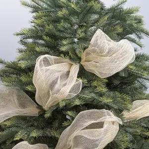 Close-up detail of golden PP mesh ribbon with glitter thread decorated on a Christmas tree