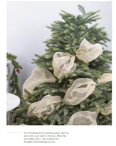 Elegant champagne gold mesh ribbon artfully draped on a lush green Christmas tree branch