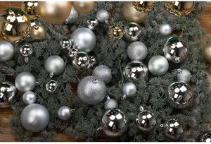 Macro detail of silver and gold Christmas ball ornaments on festive pine branches