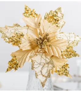 Macro detail shot of champagne gold artificial Christmas poinsettia flower with sequins