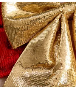 Macro view of gold sequin texture on a large Christmas decorative bow ornament