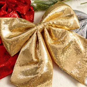 Large Christmas bow decoration with sparkly gold, red, and silver sequins.