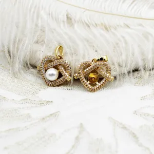 Detailed macro view of 18K gold plated heart-shaped micro-pave jewelry pendants