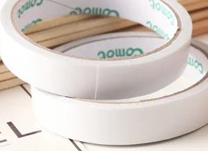 Detail shot of strong 18mm double-sided adhesive tape roll for household and office use.