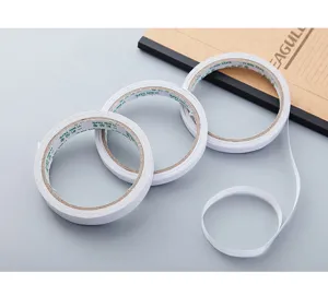Detail view of white double-sided tape rolls, strong adhesive hot-melt tape for office use.