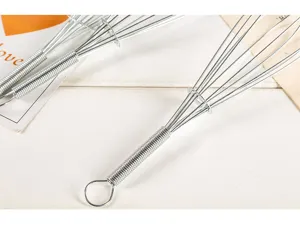 Stainless steel manual wire whisk kitchen egg beater with spring handle detail view.