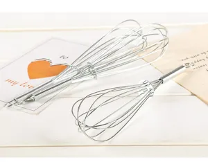 Stainless steel manual wire whisk for kitchen baking, egg beating, and cream mixing detail.