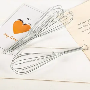 Manual stainless steel wire egg whisk kitchen tool for baking and cooking food preparation.