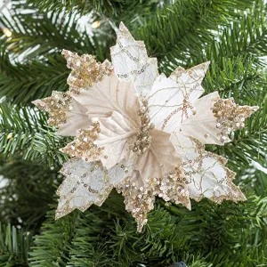Sparkling champagne artificial Christmas flower with gold sequins on a green pine tree