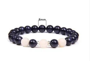 Detail view of 8mm blue sandstone and white stone beaded yoga bracelet with metal spacers.